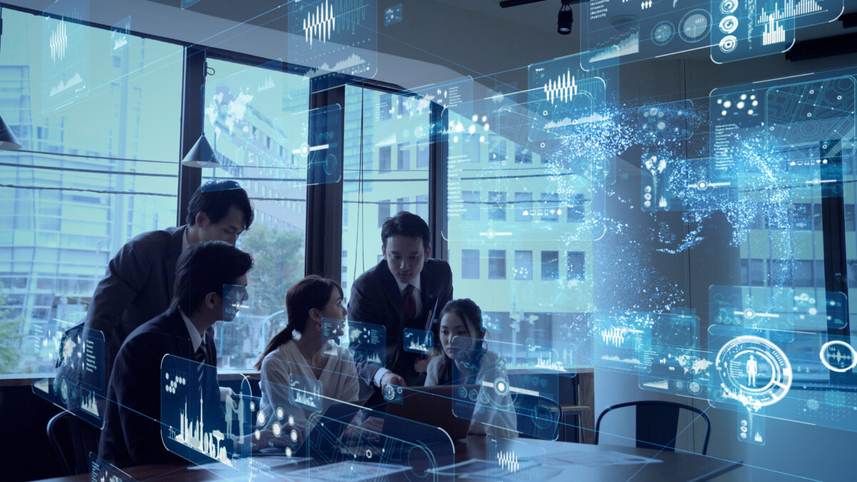 Team of professionals collaborating around a table with futuristic holographic data overlays projected in the air.